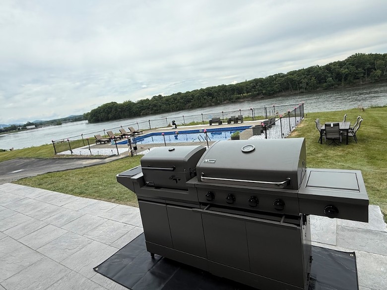 New BBQ charcoal and propane grill on new stamped concrete patio view of the backyard, pool. and amazing water views