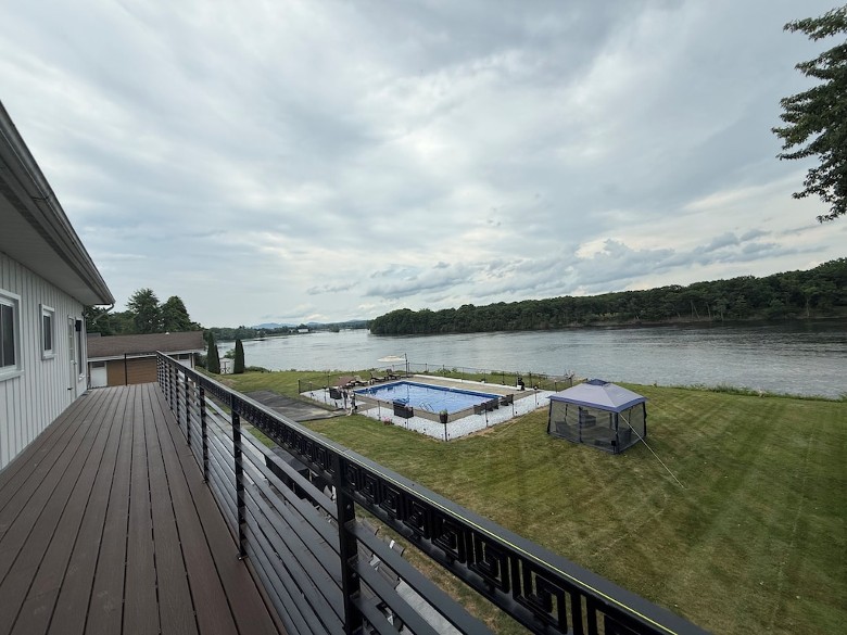 New trek deck balcony view. 4 bedrooms with direct access to outside deck. New stamped concrete patio, new BBQ, firepit, furniture, and upgraded pool heated fenced in with amazing water views.