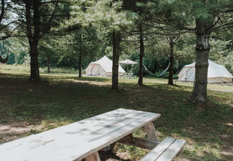 glamping tents and a picnic table