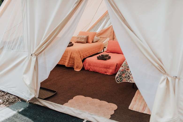 three beds inside a glamping tent