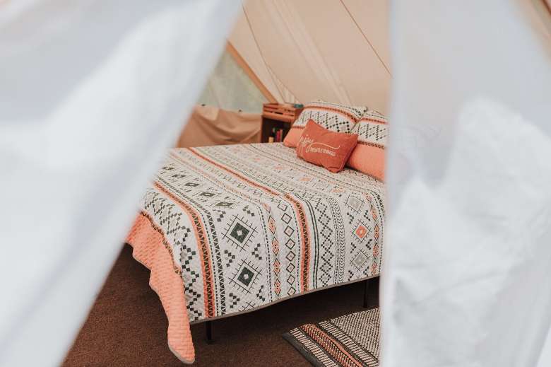 bed inside a glamping tent