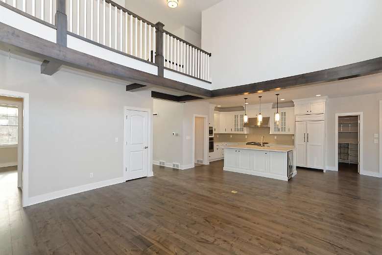 large room in a house with kitchen in the back