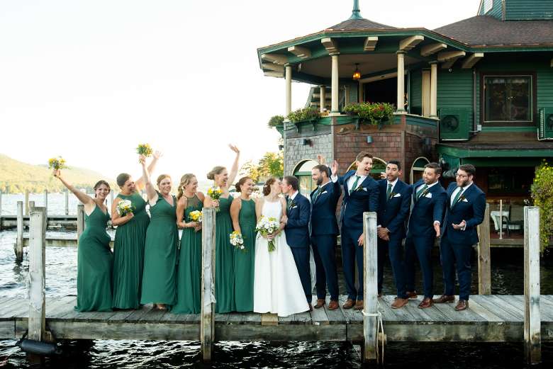 bride, groom, and bridal party on boat dock