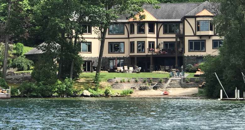large house by a lake and beach