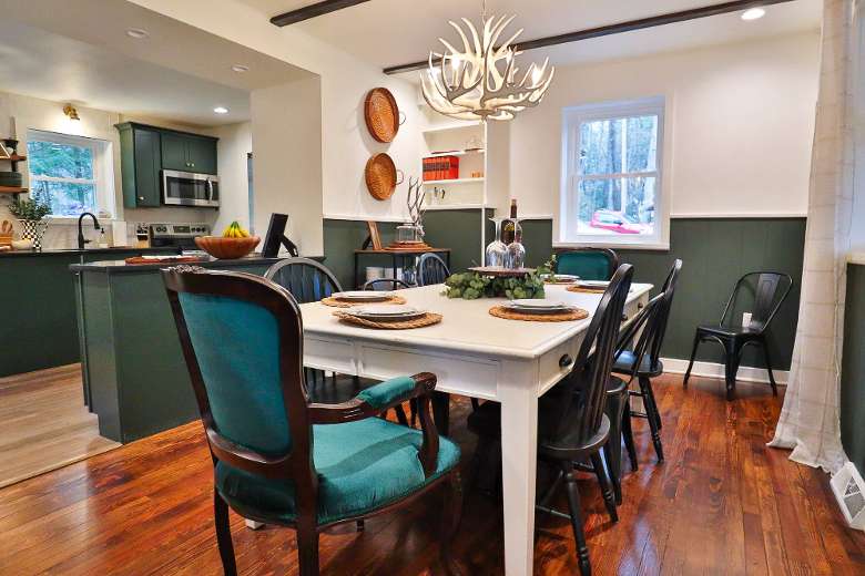 dining room table with chairs around it and plates on top
