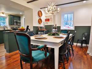 dining room table with chairs around it and plates on top