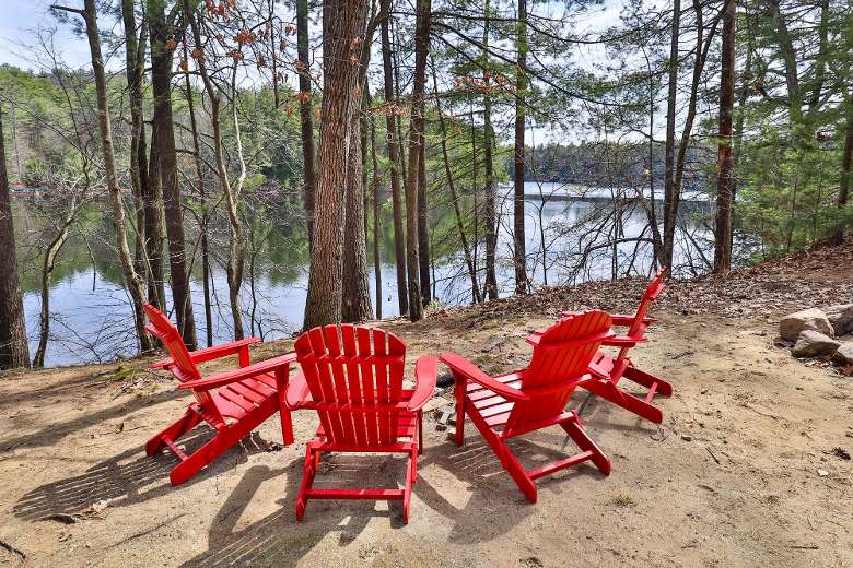 red adirondack chairs around a fire pit
