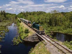 Train passing scenic bridges and marsh