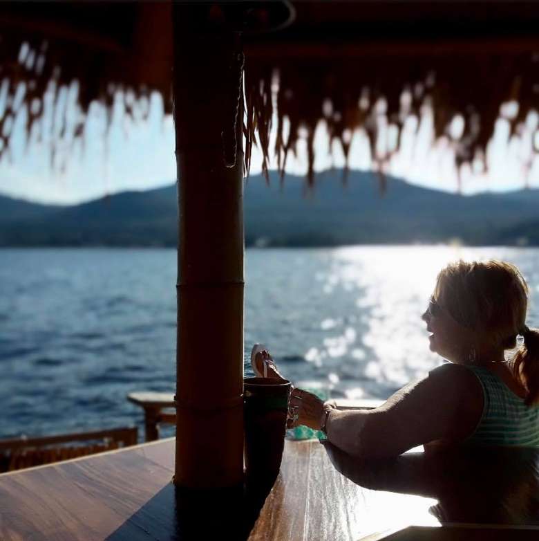 woman sitting at table on a tiki boat