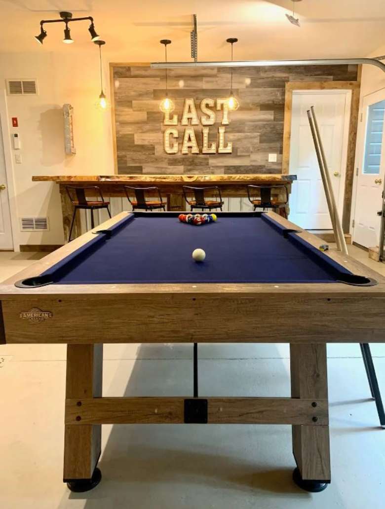 game room and bar with a pool table and sign that says last call
