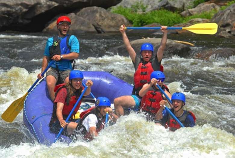group of people whitewater rafting