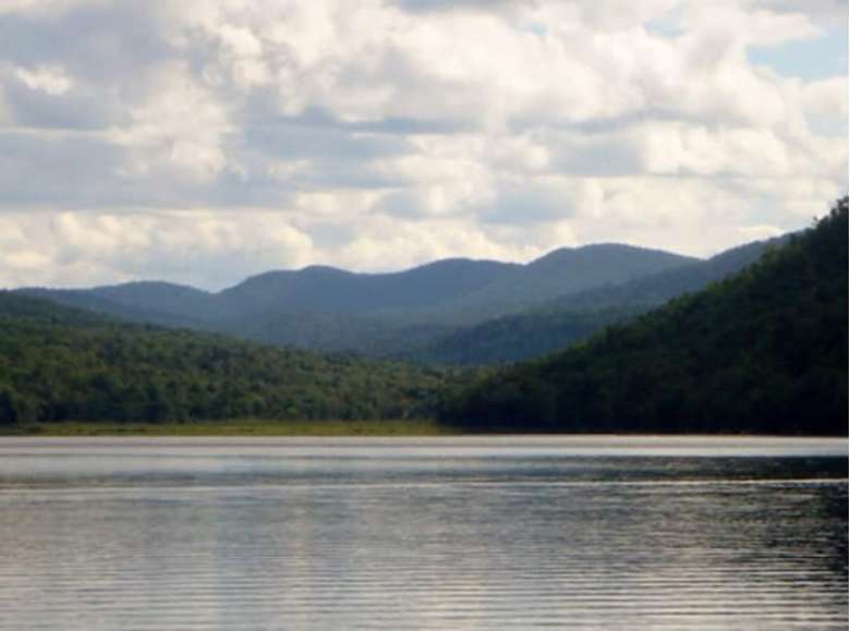 view of a lake and mountains in the distance
