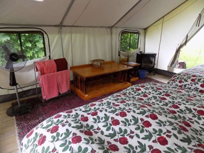 bed and table in a glamping tent