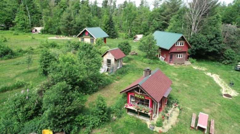 an aerial view of cabins on a scenic wooded property