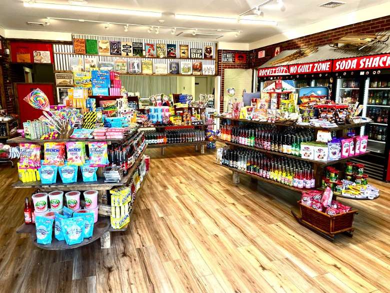 inside of a candy store with shelves of candy and soda pop