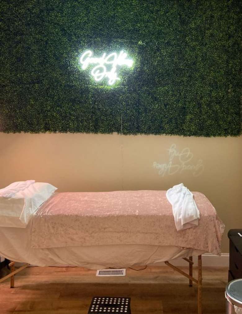 a spa bed with a light on the wall