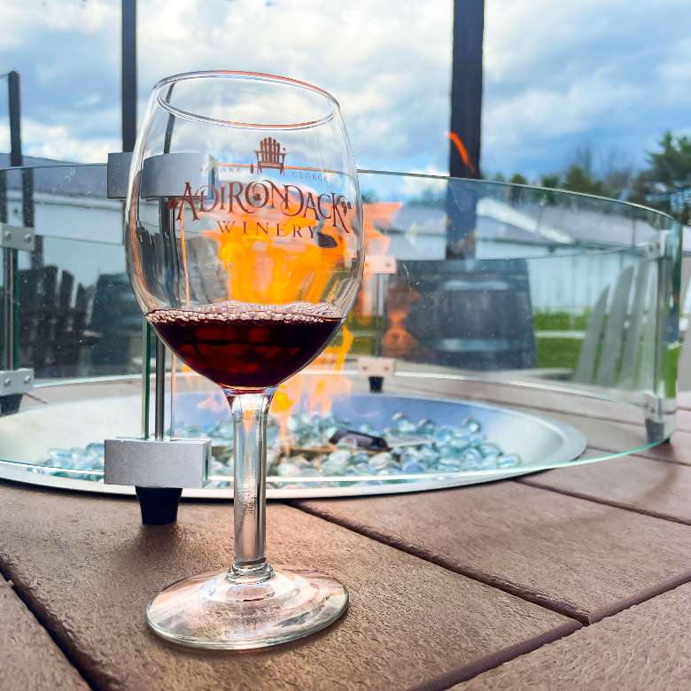 glass of wine by fire pit
