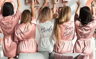 the backs of a bridal party with matching robes