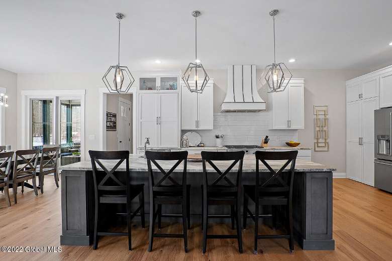 large kitchen with three lights above a kitchen island