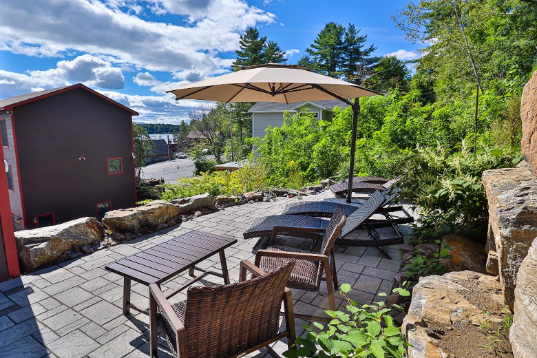 A private patio with sun loungers and an umbrella