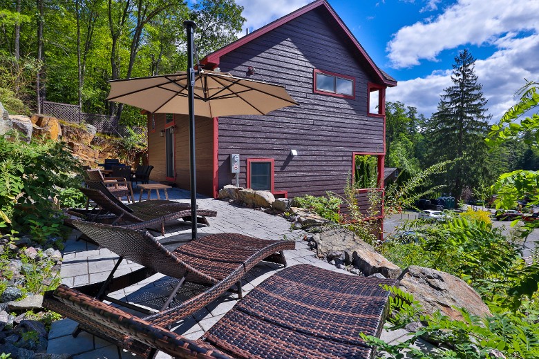 A private patio with sun loungers and an umbrella