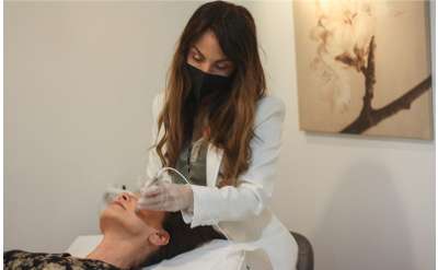 woman receiving a skin treatment on her face