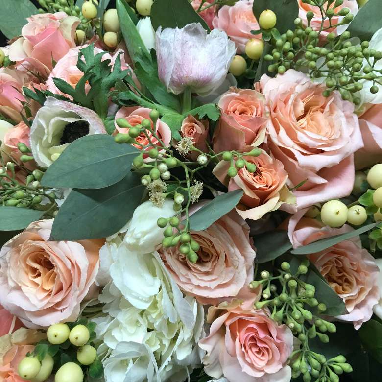 floral bouquet with peach colored and green and white flowers