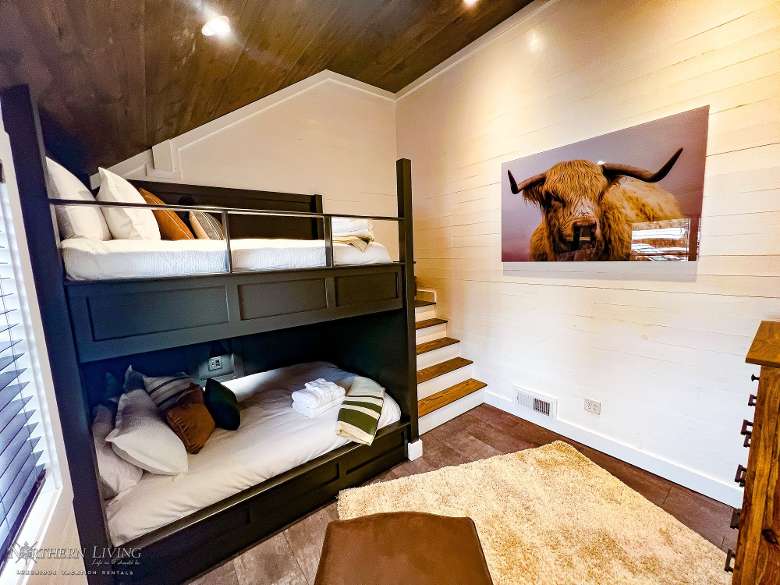 bedroom with a bunk bed and a picture of a bison on the wall
