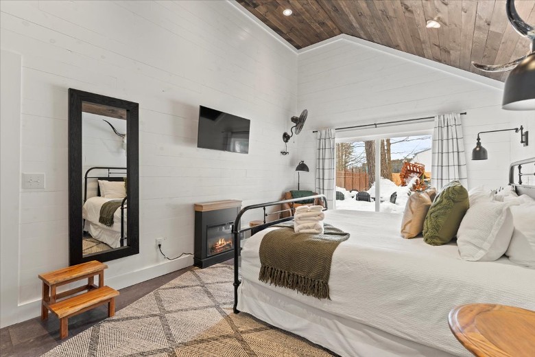 Primary King Bedroom has an electric fireplace, and sliding glass doors to the patio.