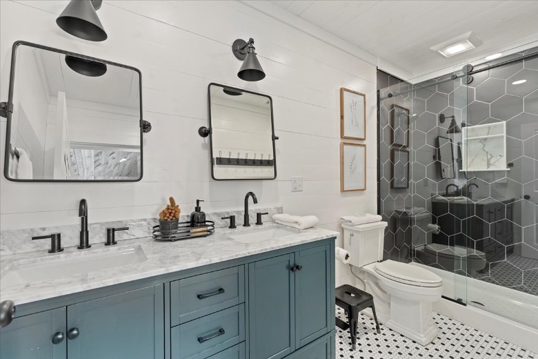 Connected to the King Bedroom. With a stand up shower and a double sink area.