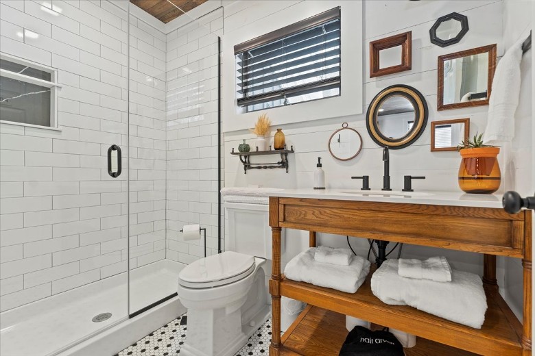 A full-size bathroom connects to the common areas with a walk-in glass shower.