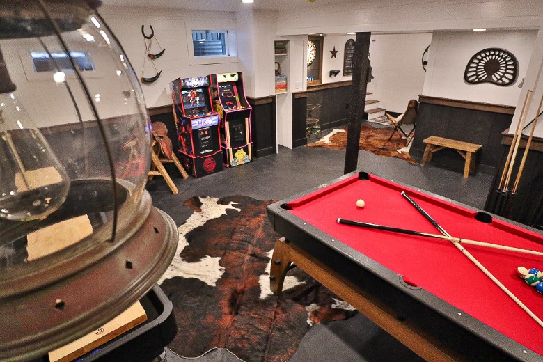 Lower Level of the property offers a bar/game room with various arcade games, pool table and shuffleboard.