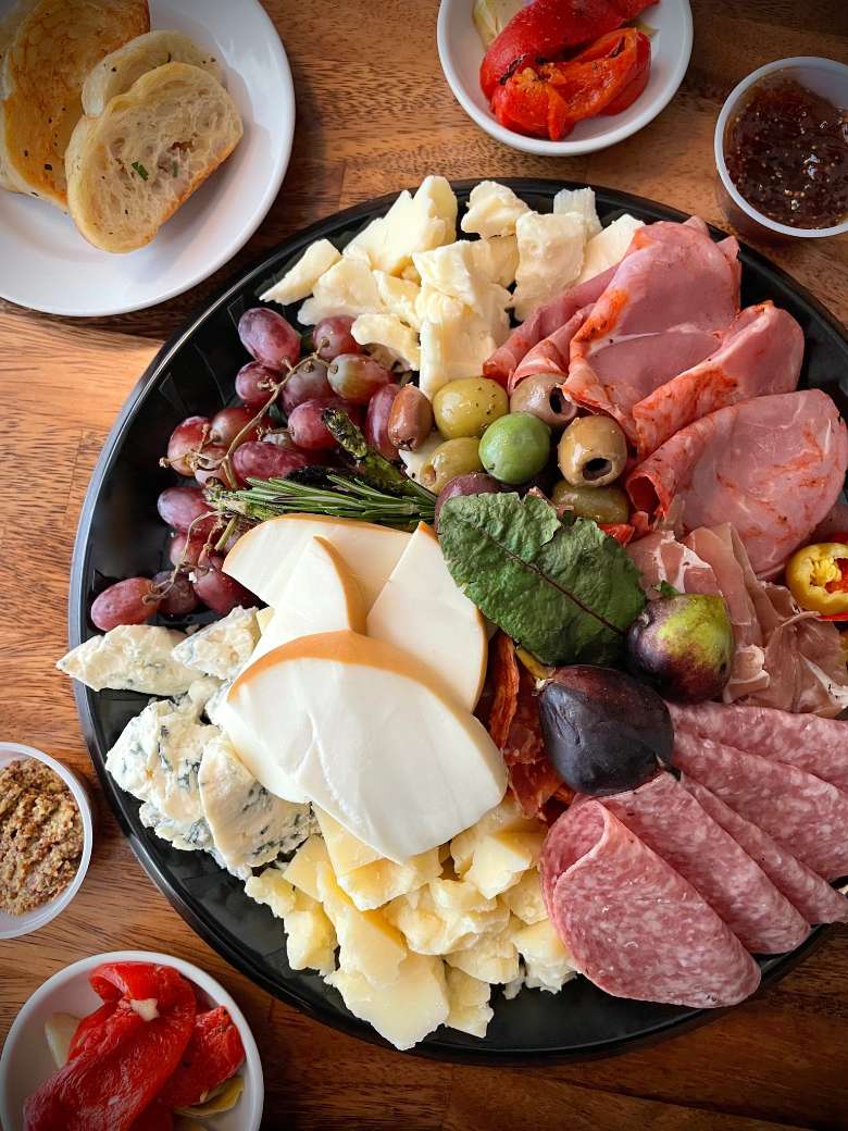 Cheese board with meats, olives, and bread