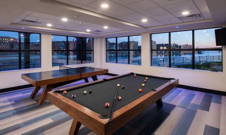 a game room with a pool table and ping pong table