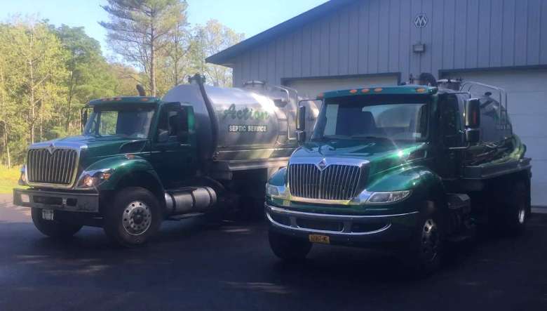 two Action Septic Service trucks
