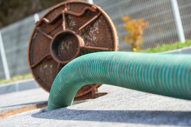 green pipe inside of a sewer