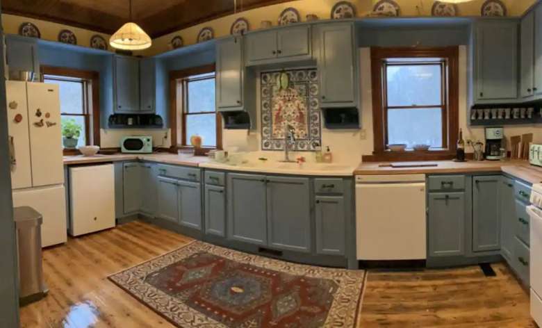large kitchen with blue cabinets, a white fridge, a dishwasher, and other appliances