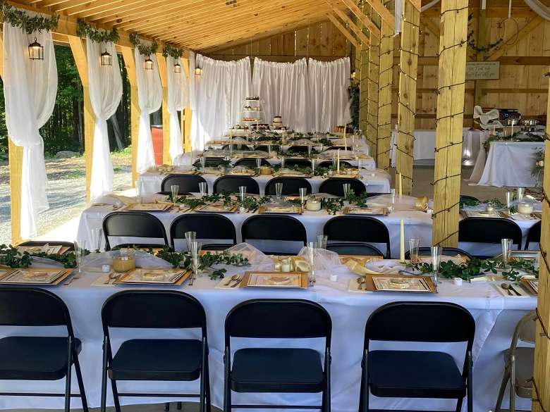 tables set up for a wedding reception in a barn space