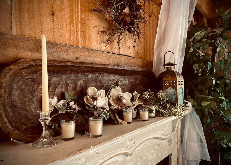 candles and flowers on a mantle