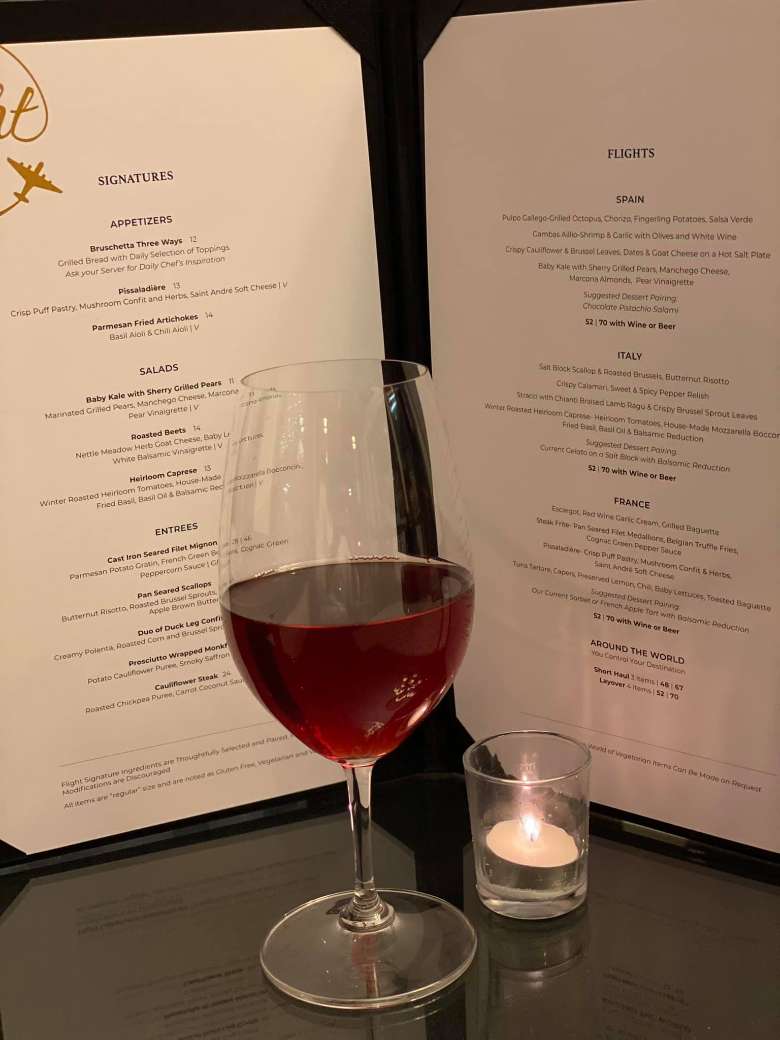 glass of red wine by wine menu