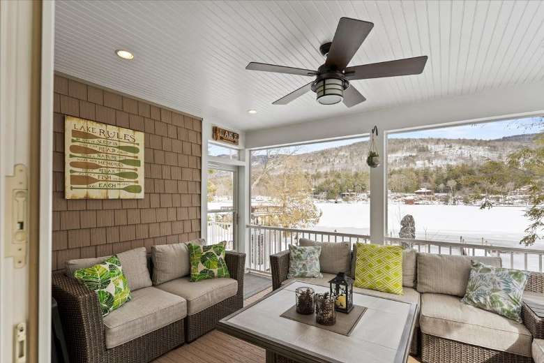 enclosed porch with views of a lake in winter