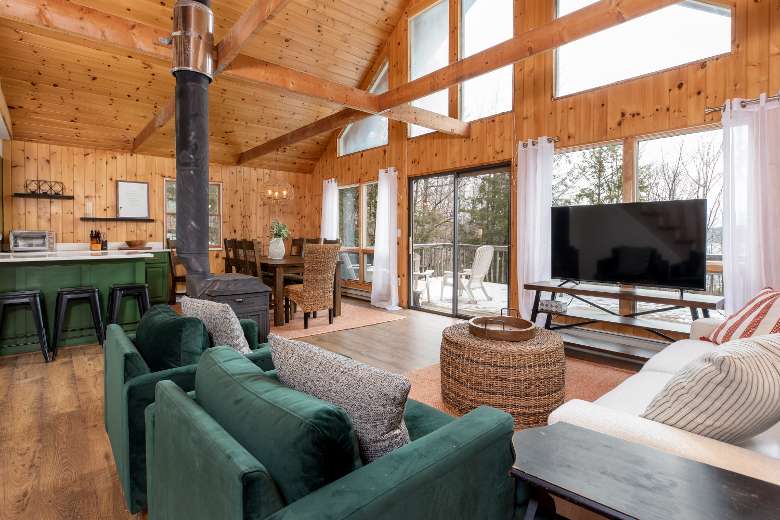spacious area of a house with a living room, fireplace, and kitchen