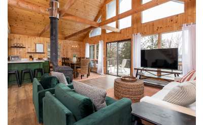 spacious area of a house with a living room, fireplace, and kitchen