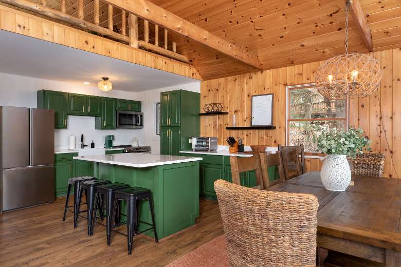 kitchen area with green cabinets and a nearby dinner table