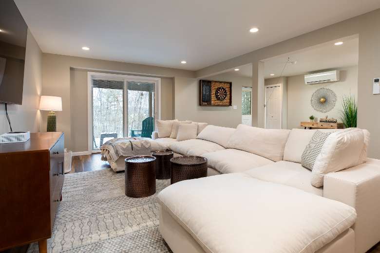 house living room with white couches and nearby sliding glass door