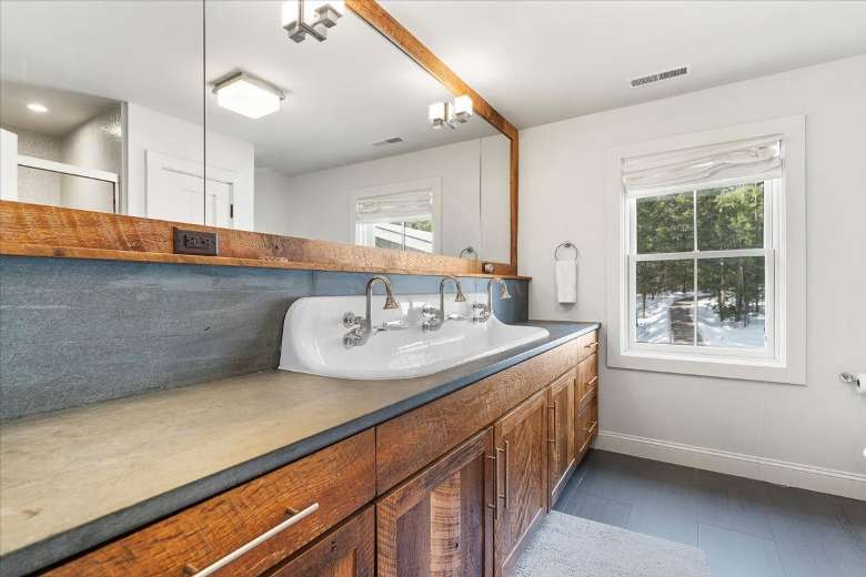 sink and large mirror in a house bathroom