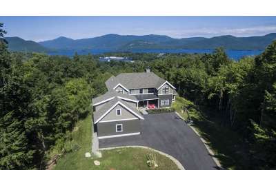 aerial view of a house that has views of the lake and mountains