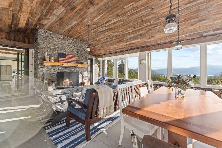 Step outside onto the screened-in porch and take in all the gorgeous views while sitting around the outdoor fireplace or enjoying a family meal around the second dining room table.