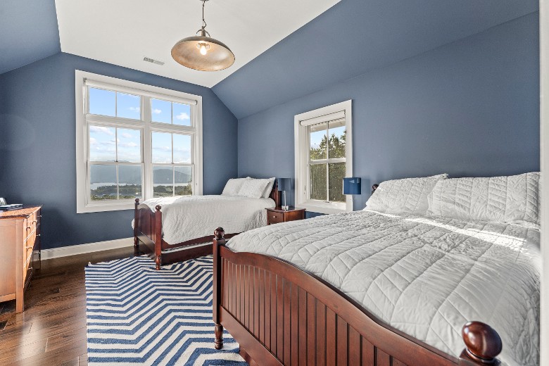 Second level bedroom with two full beds and trundles