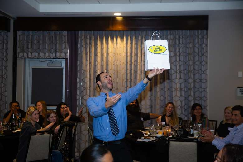 man holding up a paper bag